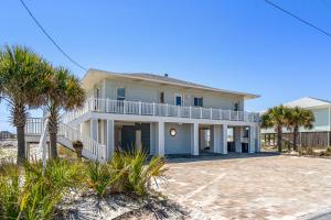 a house on the beach with palm trees at Blue Angel, Blue Angel -Gulf Front, Beautiful Views! Great for Families! in Pensacola Beach
