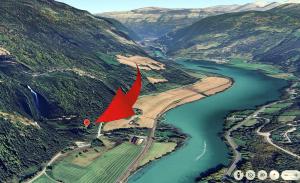 an aerial view of a river with a red flag at Waterfall Retreat in Kolo