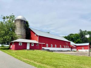 Eine rote Scheune mit einem Silo drauf. in der Unterkunft Historic Barn View Modern Country Newton House in Newton