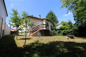 a house with a staircase on the side of it at Pompa Apartman in Nyíregyháza