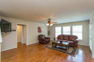 a living room with leather furniture and a ceiling fan at Huge Home For Groups Near Downtown in Nashville