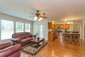 a living room with a couch and a ceiling fan at Huge Home For Groups Near Downtown in Nashville