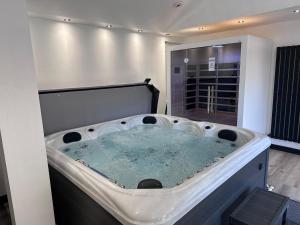 a large bath tub in a room with at The Sauna House in Stockbury