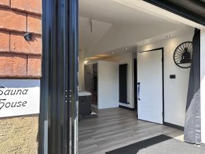 a door to a store with a sign on the wall at The Sauna House in Stockbury