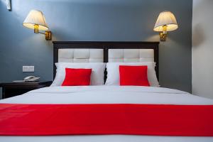 Postel nebo postele na pokoji v ubytování Mansion Inn Sibu