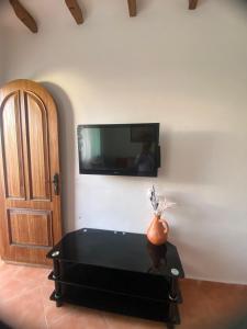 a room with a tv on a wall with a couch at Coastal Apartment in Cabo in Cabo Negro