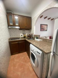a kitchen with a washer and dryer in it at Coastal Apartment in Cabo in Cabo Negro