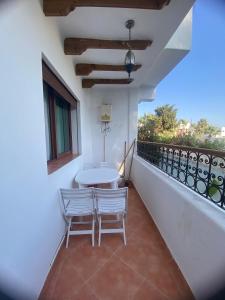 a balcony with a table and two chairs on it at Coastal Apartment in Cabo in Cabo Negro