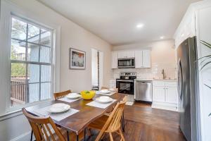 a kitchen with a table and chairs and a kitchen with white cabinets at Dilworth Dream Cottage in Charlotte