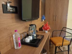 a kitchen counter with a coffee maker and a bottle of water at Yuvraj Fort Pushkar by Data Mansa Hukam Pvt Ltd in Pushkar