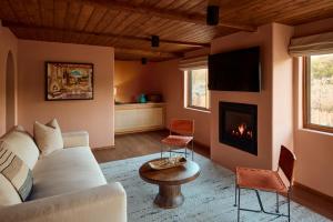 a living room with a couch and a fireplace at Hotel Willa in Taos