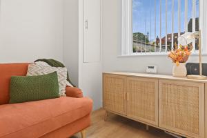 a living room with a orange couch and a window at Stylish 4 Bed House In Chorley in Chorley