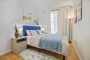 a bedroom with a large bed and a window at Relaxed 2BR in Manhattan Valley in New York
