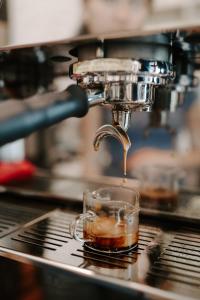 a cup of coffee is being brewed at Hotel Bayit in Salida
