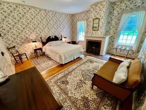 a bedroom with a bed and a fireplace at Bailey's Mills Bed & Breakfast 