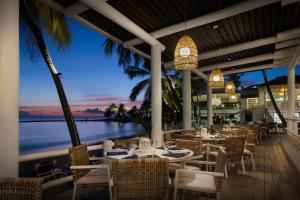 a restaurant with tables and chairs and a view of the ocean at Windjammer Landing Resort and Residences in Gros Islet