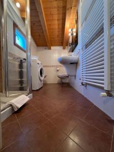 a bathroom with a toilet and a sink and a shower at Welcome Traveller Residenza Salier in Garda +17 photos