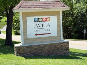 a sign for a library sits on a lawn at Avila Serenity Suites - For 6 in Lake Ozark