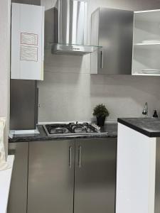 a stainless steel kitchen with a stove top oven at Laylak House in Salor Bekati