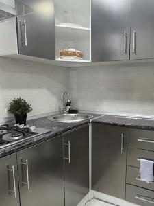 a kitchen with a sink and a stove at Laylak House in Salor Bekati +6 photos