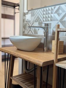 a bowl sink on a wooden table in a kitchen at Casa MaLù in Aci Bonaccorsi +40 photos