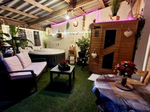 a room with a tub and a couch and a table at Studio19 Cosy Sauna Jacuzzi et jardinet privatifs in Draguignan +52 photos