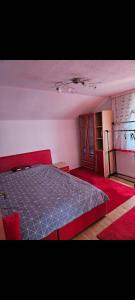 a bedroom with a bed with a blue comforter at Apartment Bistrik in Sarajevo