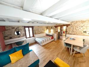 a living room with a bed and a table at Superbe Studio Roustique in Saint-Jean-de-Gonville
