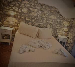 a bed with two pairs of underwear and towels on it at Casa Pitorna in Gratteri