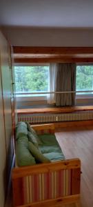 a bunk bed in a room with a window at Appartamento Artuik Marilleva 1400 in Marilleva