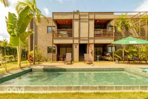 ein Haus mit einem Swimmingpool vor einem Gebäude in der Unterkunft Villa Kamby na Rota Ecológica dos Milagres by Qavi in São Miguel dos Milagres