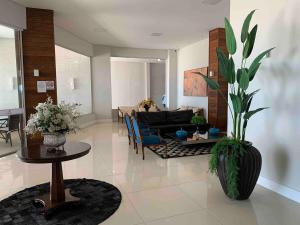 a living room with a couch and a table at Apartamento fantástico com linda vista lateral do mar in Balneário Camboriú