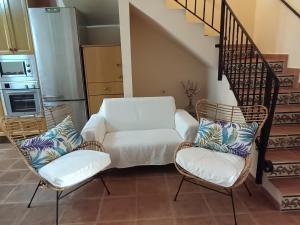 a living room with two chairs and a couch at La Senia in Moncófar +34 photos
