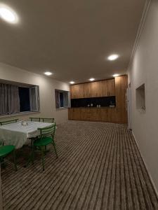 a room with a table and chairs and a refrigerator at Mountain view in Gabala in Bunud +32 photos