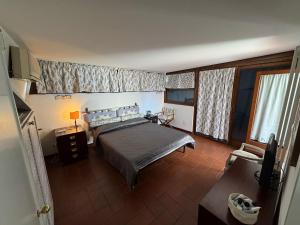a bedroom with a bed in a room with windows at Casa del Marinaio in Marina di Carrara