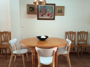 a dining room table with chairs and a bowl on it at La Senia in Moncófar