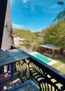 a balcony with a table and a swimming pool at Finca en Santiago del Estero in La Banda +4 photos
