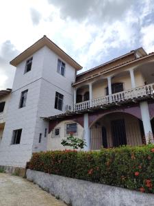 a white building with a balcony on the side of it at COP 30 Mosqueiro Castle in Belém