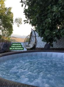a hot tub in a yard with a swing at Villa Cultural MONTELUCÍA in Montecorto +74 photos