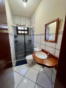 a bathroom with a sink and a toilet at Pousada Murmúrio das Águas in São Francisco Xavier +35 photos