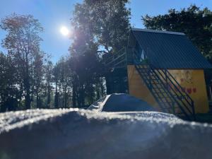 a tent in front of a building with the sun at Croft Yelagiri - glamping stay in Yelagiri