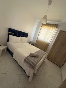 a bedroom with a large bed and a window at perle de bouznika 15min walking to the beach plus free unlimited WiFi in Bouznika +11 photos
