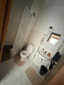 a bathroom with a toilet and a sink at perle de bouznika 15min walking to the beach plus free unlimited WiFi in Bouznika