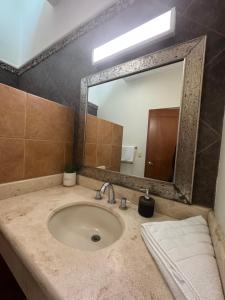 a bathroom with a sink with a large mirror at Casa de playa, a pasos del mar in Mazatlán +15 photos