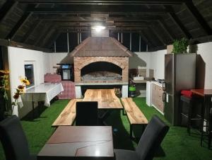 a kitchen with a large fireplace in the middle of a room at Resort La Familia in Bihać