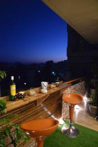 a balcony with two stools and a table on a building at Pantelia LuxMax Experience in Loutraki