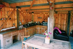 a kitchen with a table in a cabin at Quantock View Glamping Tent in Draycott