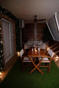 a table and chairs in a living room with a couch at Pantelia LuxMax Experience in Loutraki