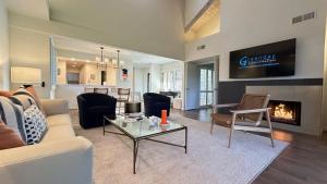 a living room with a couch and a fireplace at Racquet Club Retreat Modern Luxe Living in a Peaceful Desert Escape – managed by Greenday in Rancho Mirage