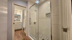a bathroom with a shower with a glass door at Racquet Club Retreat Modern Luxe Living in a Peaceful Desert Escape – managed by Greenday in Rancho Mirage +7 photos
